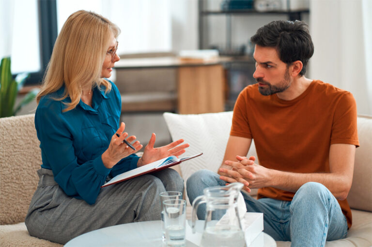 counselor speaking with patient on couch
