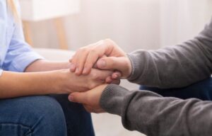 supportive holding hands