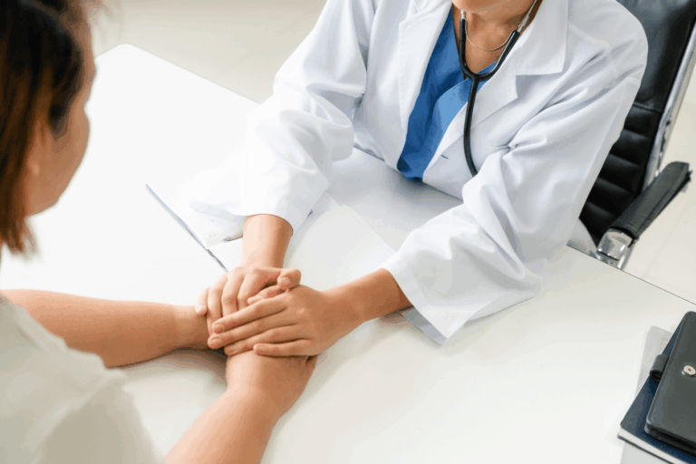 doctor showing support to a patient by holding their hands