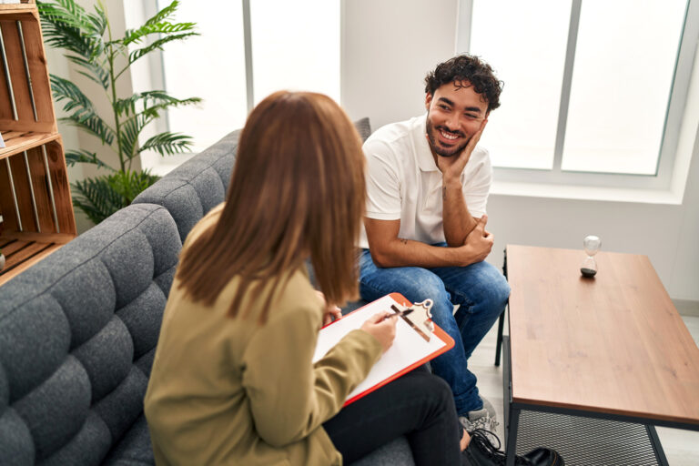 addiction counselor meeting with a patient in a living room setting