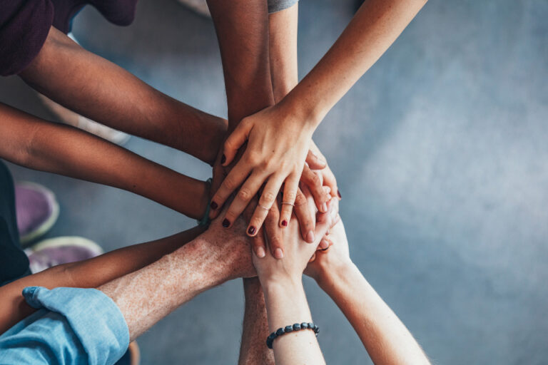 group of hands in a circle