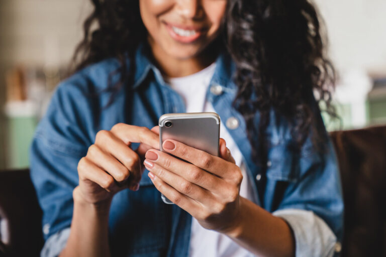 woman using a smartphone to pay ahead