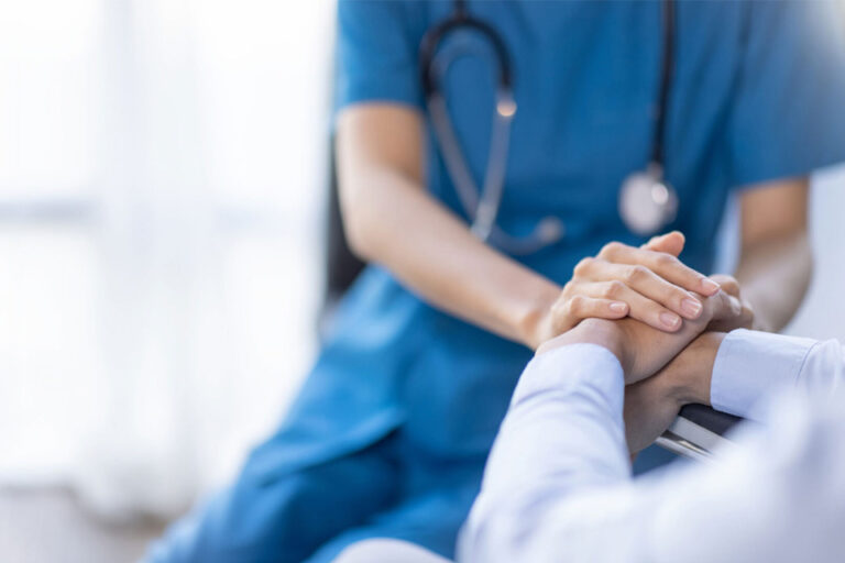 medical professional holding the hand of their patient