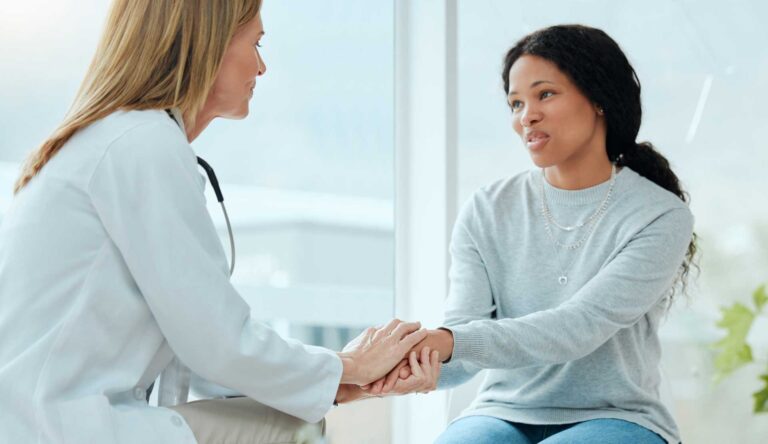 doctor supporting an expectant mother during opioid use disorder treatment